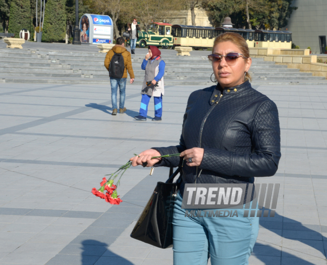 Baku residents bringing flowers to Seaside Boulevard to honor missing oil workers.  Azerbaijan, Dec.07, 2015